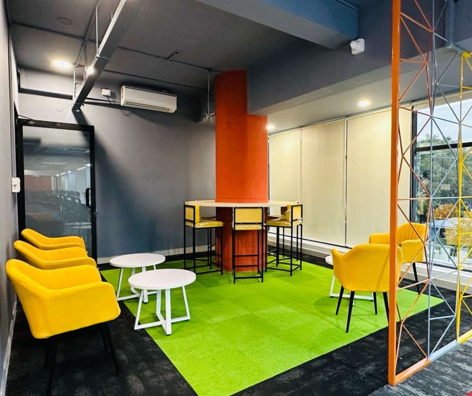 Relaxing breakout area in a coworking space in HSR Layout with comfortable seating and a vibrant ambiance.